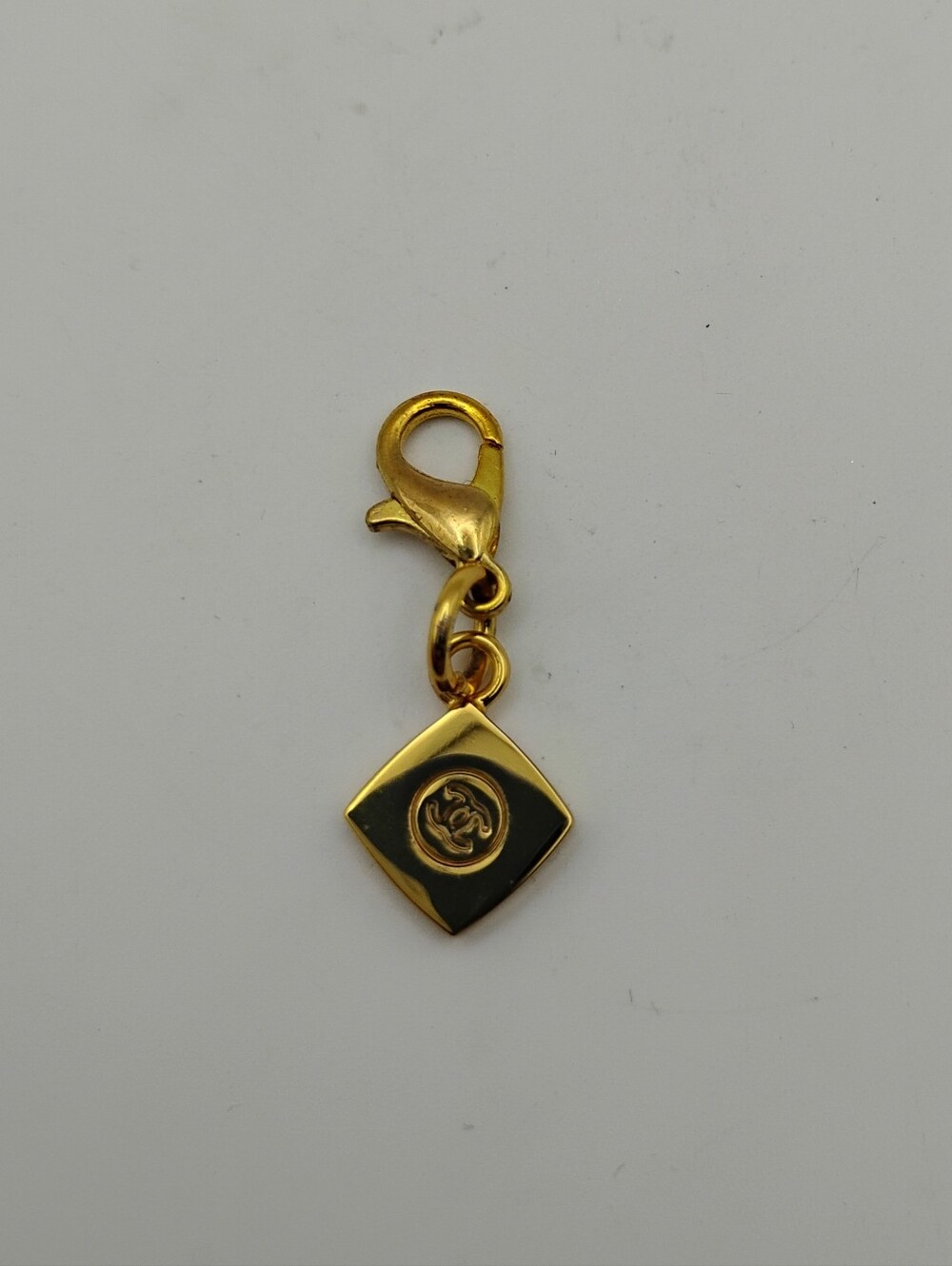 CHANEL Gold and Black Square Charm with CC Logo